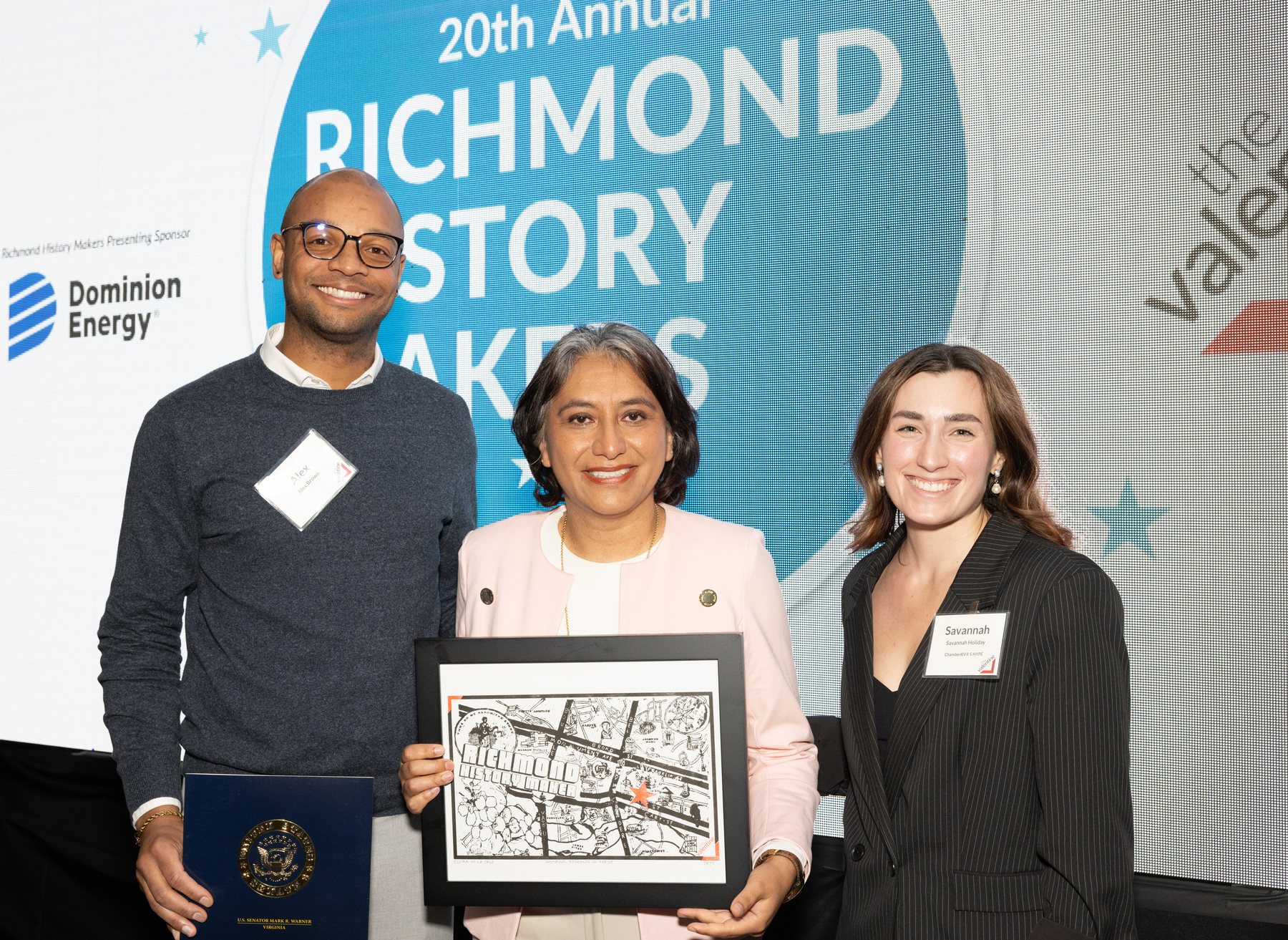 Elvira holding her Richmond History Maker award with event representatives